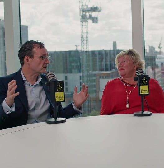 Two Hogan Lovells employees talking on a podcast